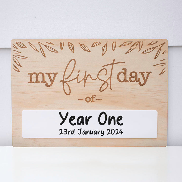 Double-sided wooden back-to-school board showing "my first day of" side including acrylic space with school year and date written.
