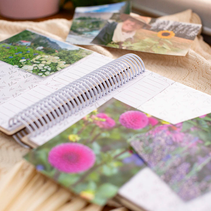 Closeup view of inside of Hello Fern custom wooden photo album sleeves with pictures scattered around.