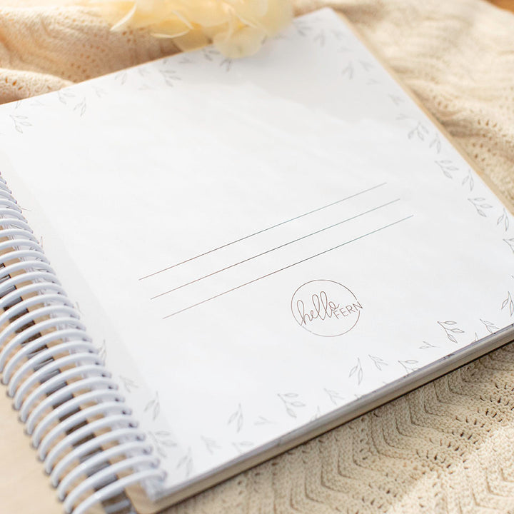Closeup of blank title page inside Hello Fern wooden photo album.
