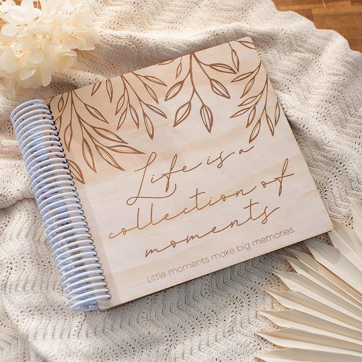 Hello Fern custom wooden photo album cover with personalised etched title and subtitle on baby blanket with neutral tones.