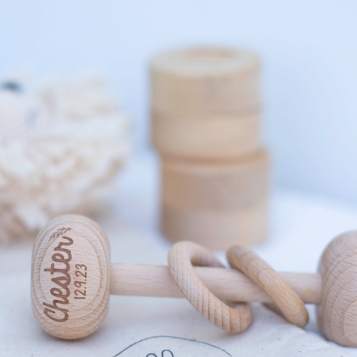 Wooden rattle with custom baby name and birth date details etched on to top of rattle.