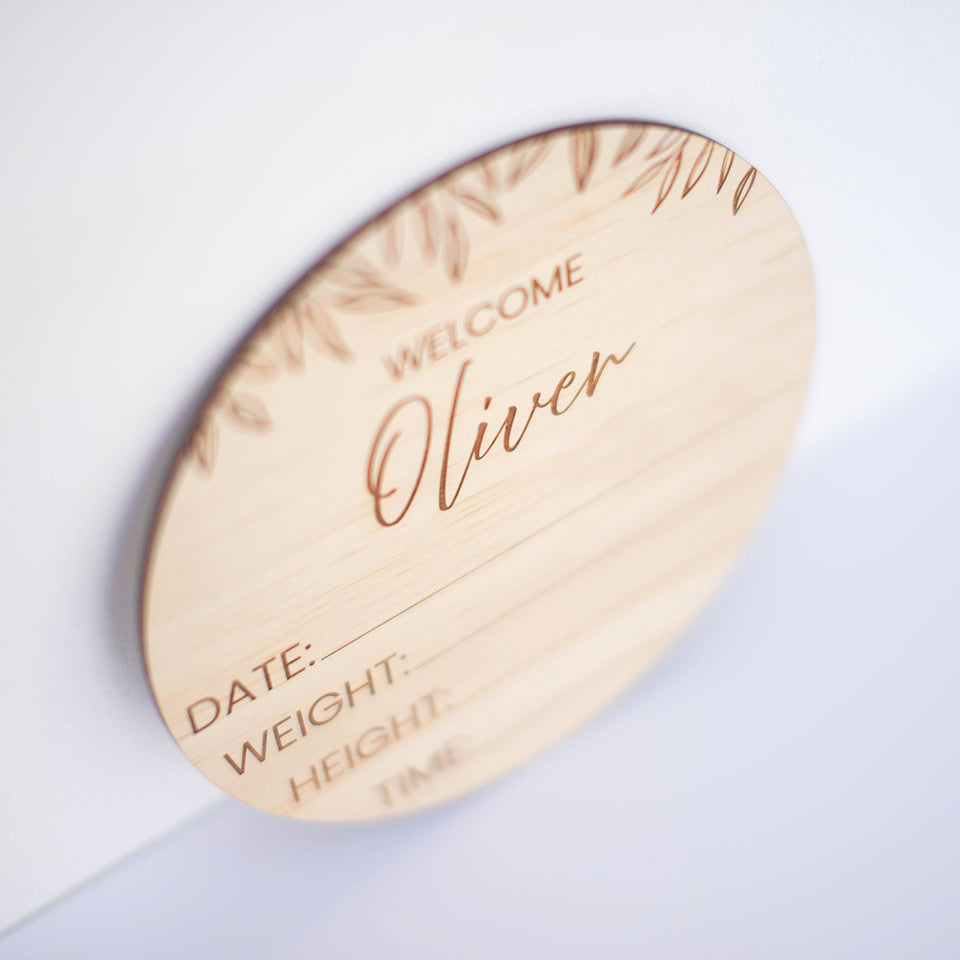 Closeup view of Hello Fern custom wooden birth announcement disc.