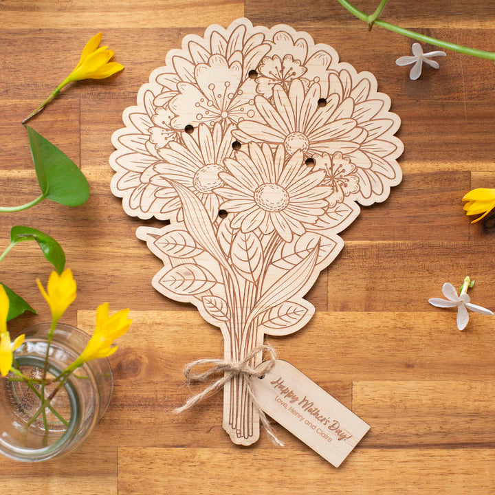 Top view of wooden Hello Fern Mother's Day flower bouquet showing holes for spaces for picked garden flowers.