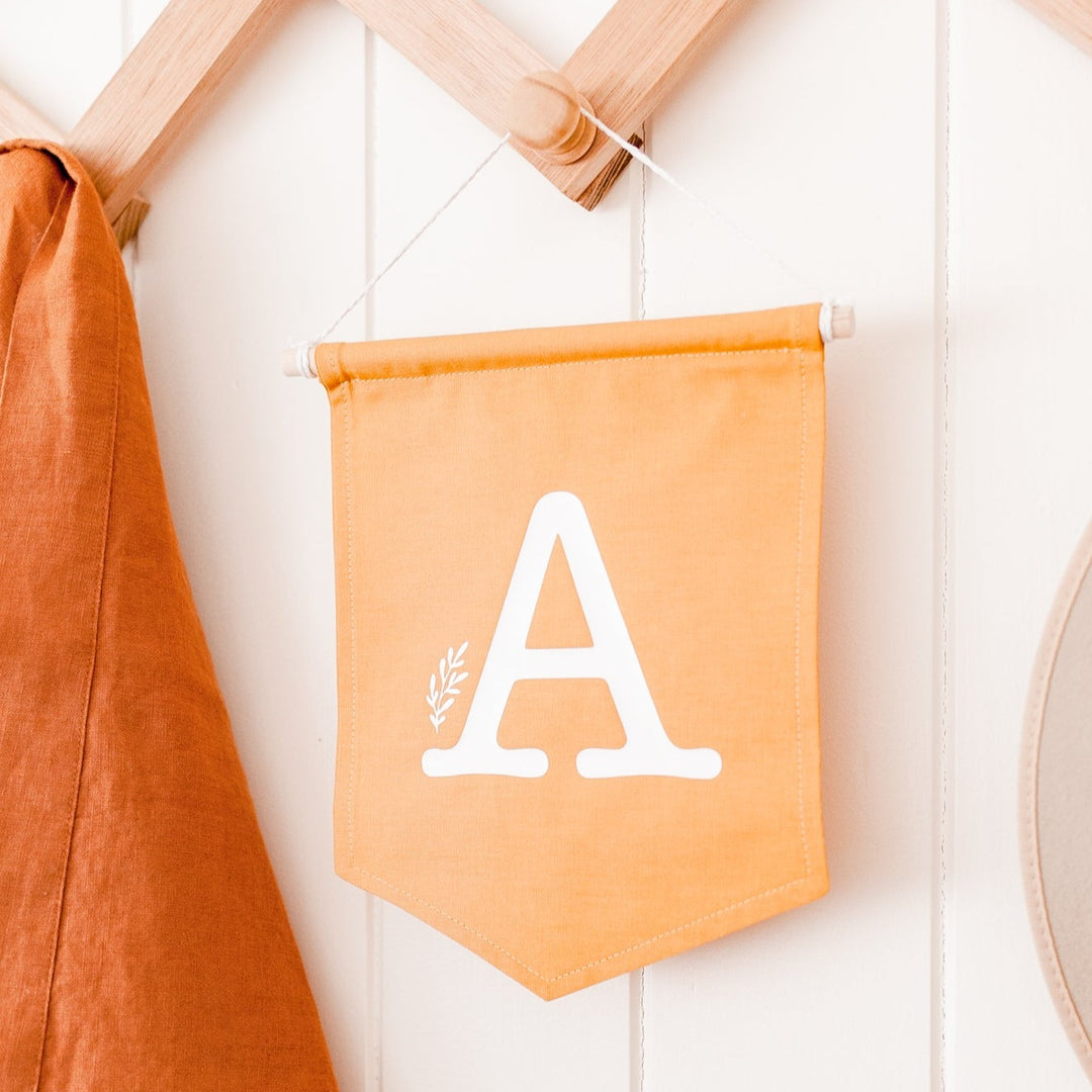 Letter flag wall hanging - Mustard with white letter