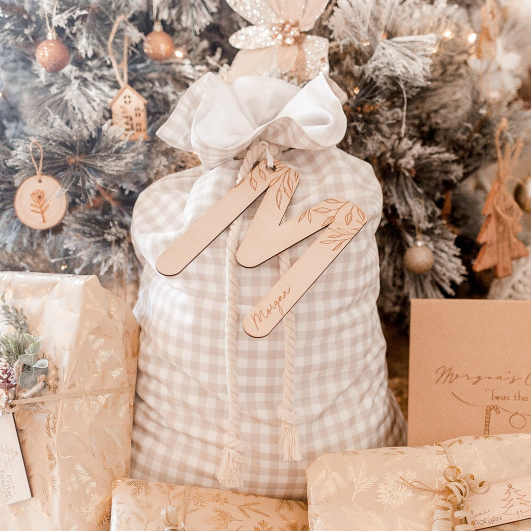Brown Christmas Santa sac with wooden letter 'M' plaque and name 'Morgan' etched into plaque.