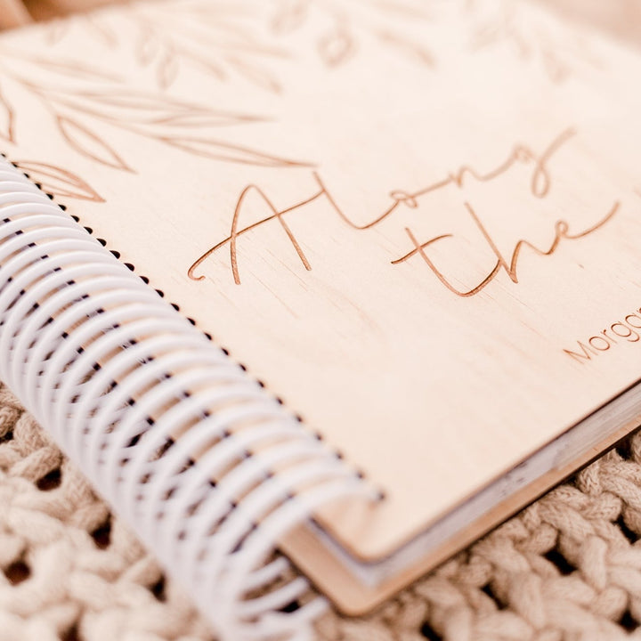 Closeup view of custom etched wooden cover and coil of a Hello Fern photo album.