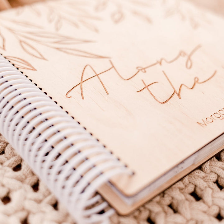 Closeup view of custom etched wooden cover and coil of a Hello Fern photo album.