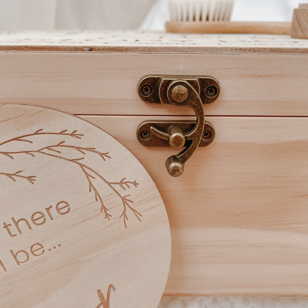 A close up view of the secure vintage looking latch. The latch is closed and is on a large wooden keepsake box.