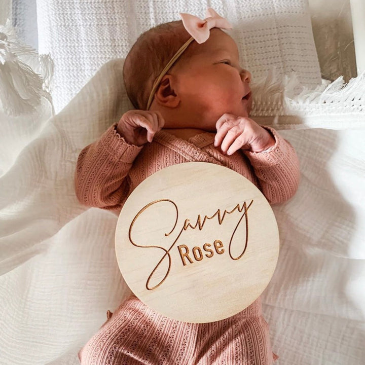 Baby girl with Hello Fern classic wooden name plaque cusotmised with baby's name.