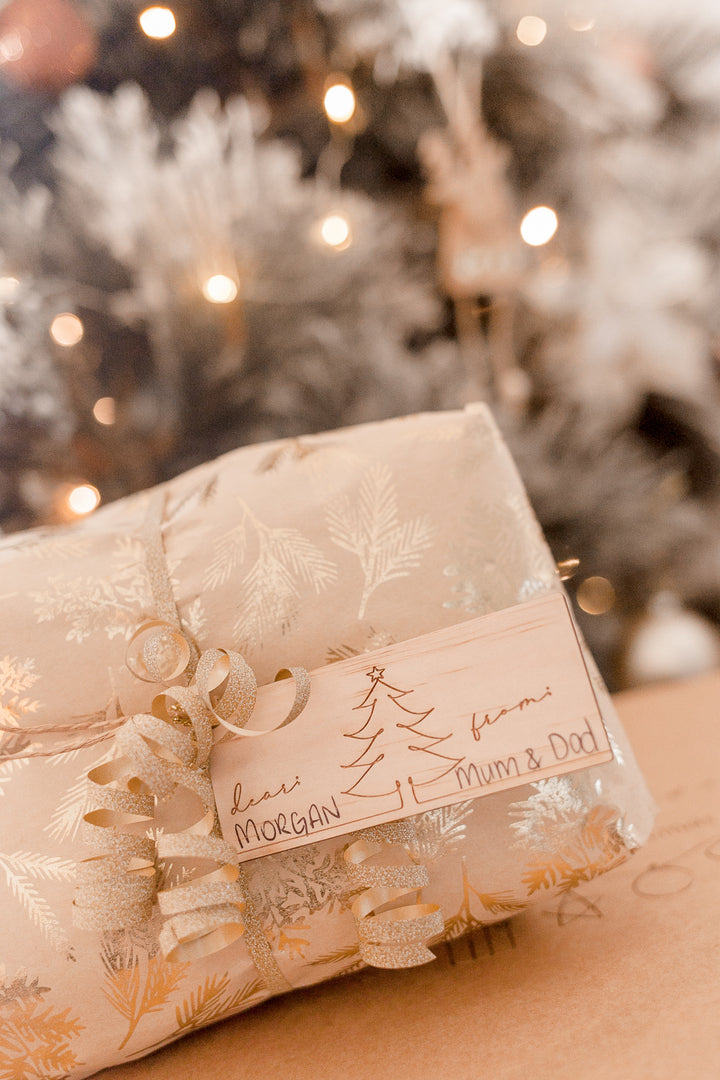 Image of non-custom Christmas gift tag with Christmas tree design etched into wood.
