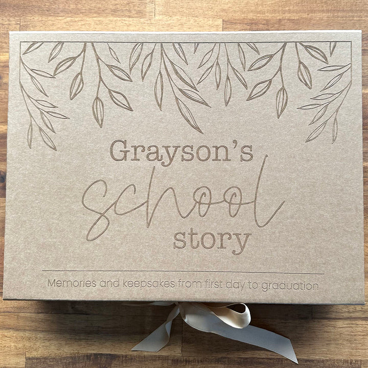 Top view example of custom kraft "My School Story" keepsake box etched with child's name and fits school story book.