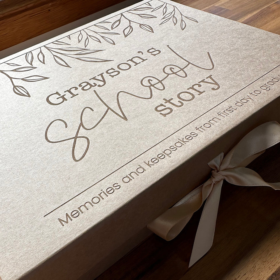 Example of custom kraft "My School Story" keepsake box etched with child's name and fits school story book.