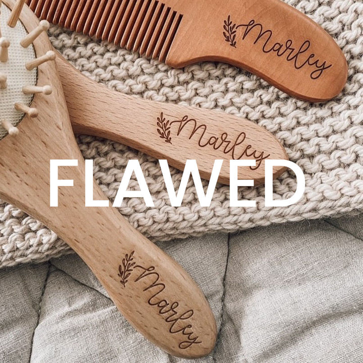 Closeup view of names etched on to the Hello Fern custom baby brush set using Font 2 with word FLAWED.