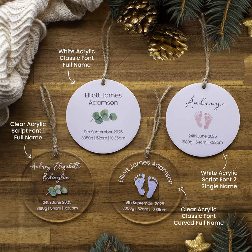 Four Hello Fern personalised acrylic baby Christmas ornament discs custom printed with birth details on a wooden surface with decorative elements and descriptions.