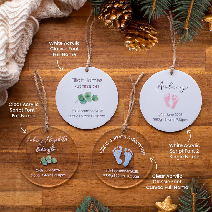 Four Hello Fern personalised acrylic baby Christmas ornament discs custom printed with birth details on a wooden surface with decorative elements and descriptions.