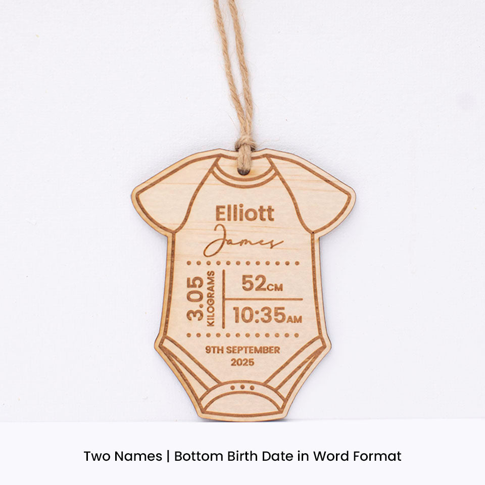 Hello Fern custom wooden baby onesie-shaped ornament with engraved baby birth details including first and last name on a white background.