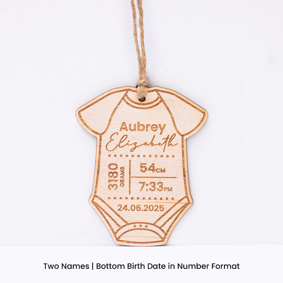 Hello Fern custom wooden baby onesie-shaped ornament with engraved baby birth details including first and last name on a white background.