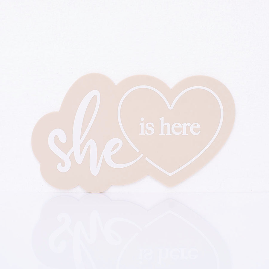 Hello Fern beige acrylic "she is here" birth announcement plaque in a goregous heart shape minimalist design.