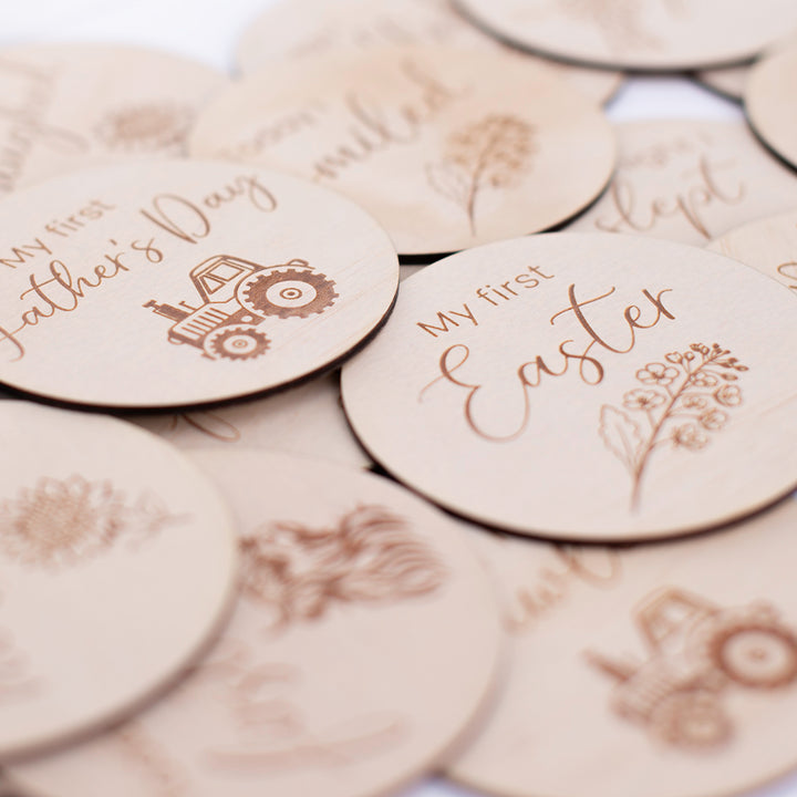 Closeup view of Hello Fern country-themed wooden achievement milestone card discs.