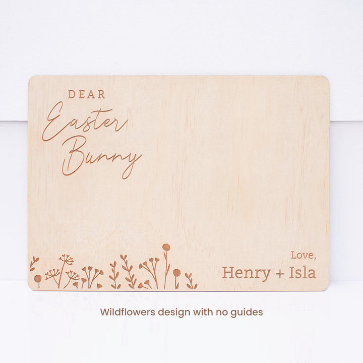 Hello Fern custom timber Easter Bunny snack board with wildflowers design shown isolated against white wall.