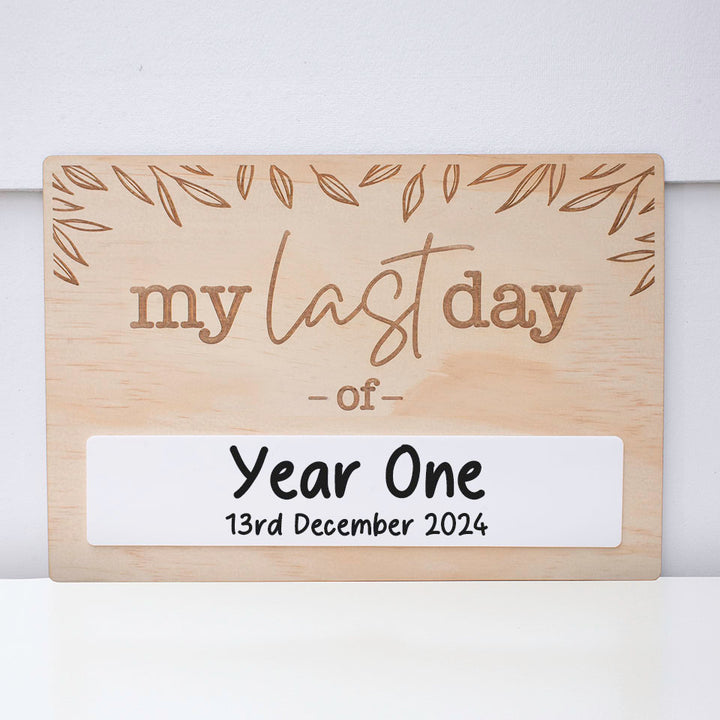 Double-sided wooden back-to-school board showing "my last day of" side including acrylic space with school year and date written.