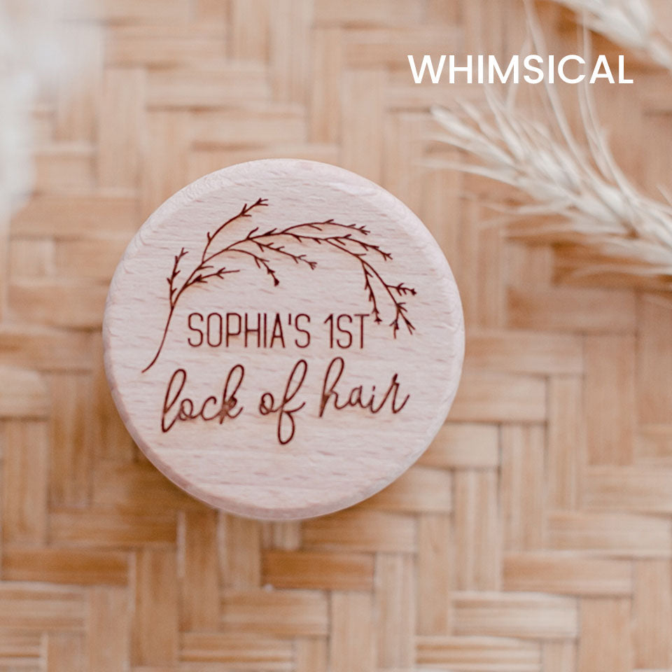 Closeup of Hello Fern baby's first lock of hair wooden trinket box in whimsical style, custom laser-engraved with child's name shown on lid.