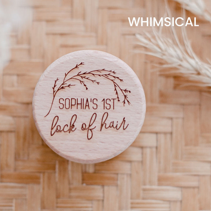 Closeup of Hello Fern baby's first lock of hair wooden trinket box in whimsical style, custom laser-engraved with child's name shown on lid.