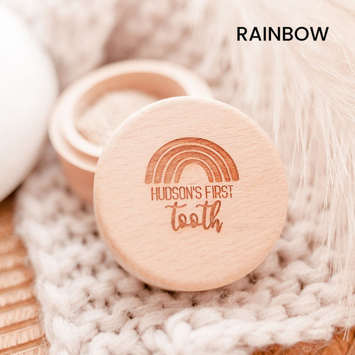 Closeup of Hello Fern baby's first tooth wooden trinket box in rainbow style, customised with child's name shown with lid open.