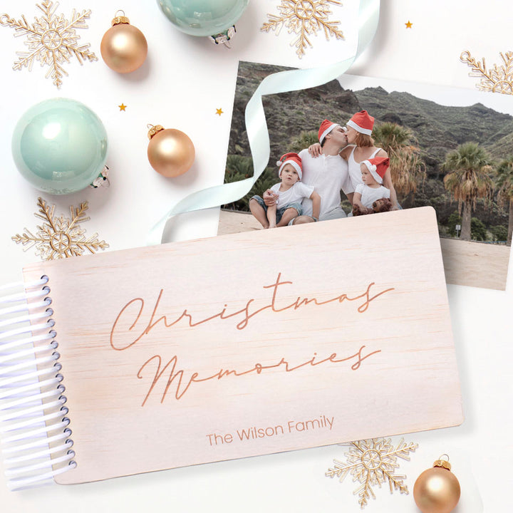 Christmas-themed personalised wooden photo album by Hello Fern with family photo and decorative ornaments on a white background