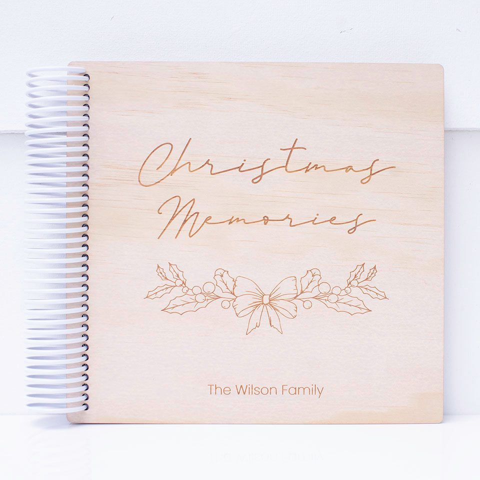 Custom etched Hello Fern wooden Christmas photo album shown on white background.