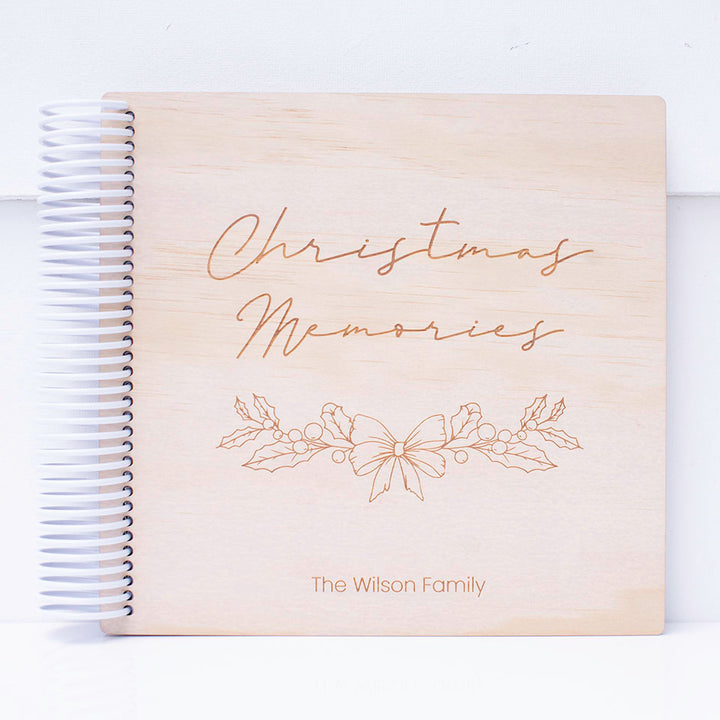 Custom etched Hello Fern wooden Christmas photo album shown on white background.