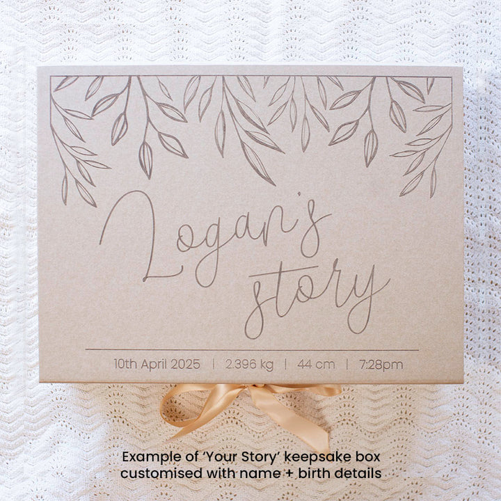 Top view example of optional extra kraft keepsake box in 'Your Story' design with baby's name and birth details, which can store Hello Fern's wooden baby memory book.