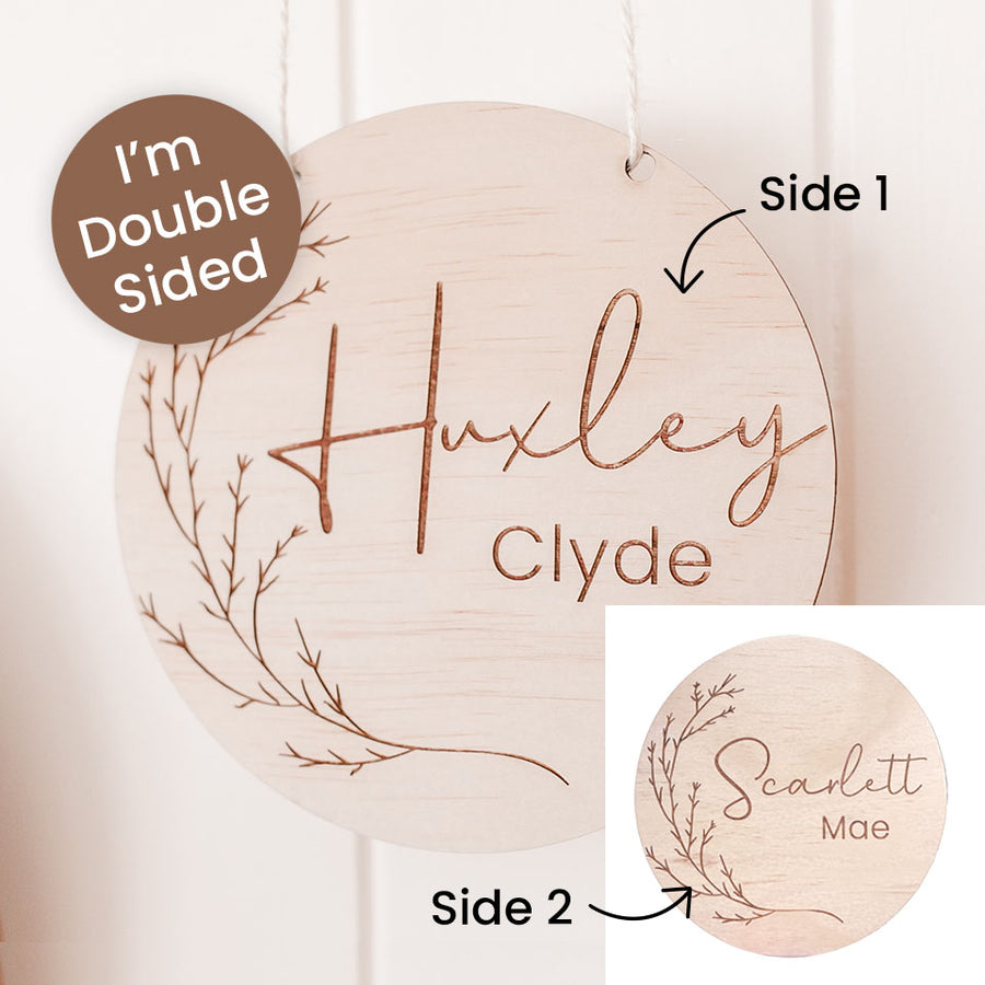 Hello Fern wooden name plaque with 'Huxley Clyde' on one side and 'Scarlett Mae' on the other, showing double-sided design.