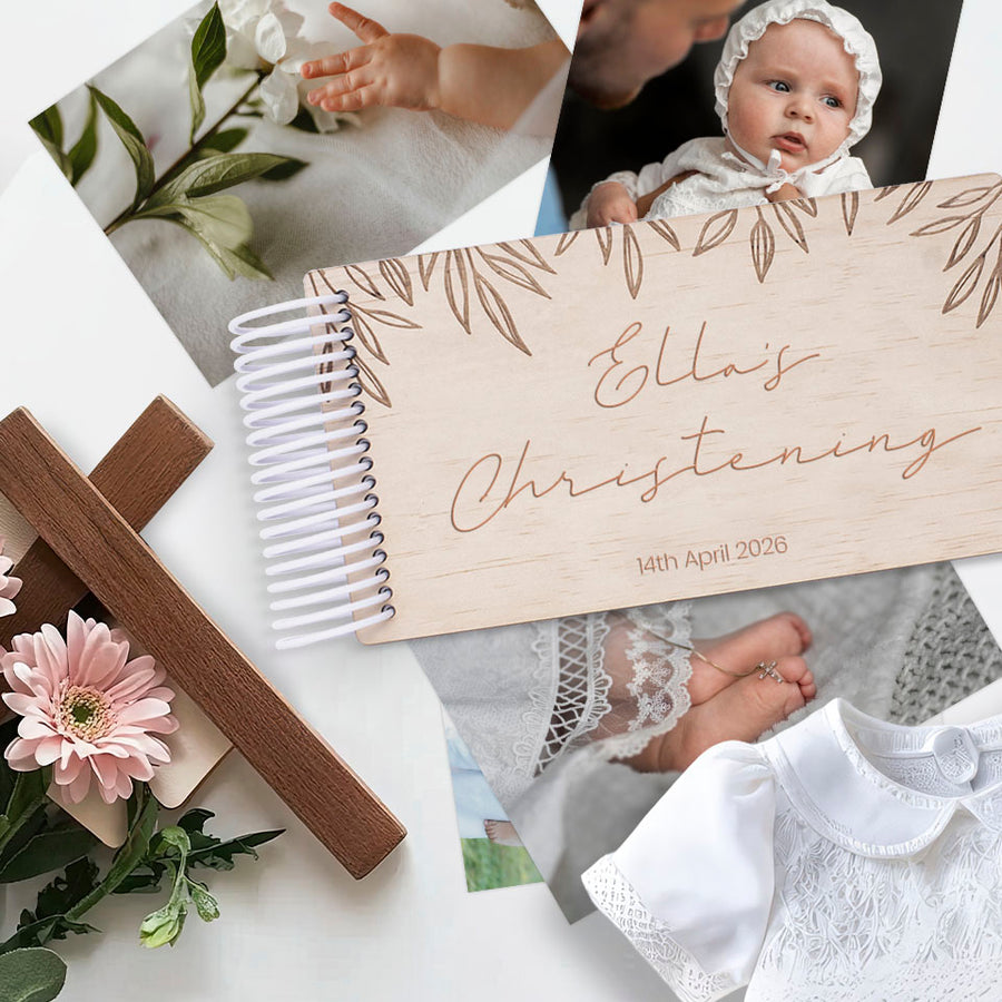 Hello Fern mini wooden photo album with Baptism theme titled 'Ella's Christening' with baby photos and items on a white surface.