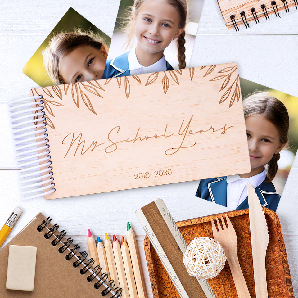 Flatlay displaying Hello Fern custom wooden mini photo album with "My School Years" theme, school portrait photographs, and school supplies.