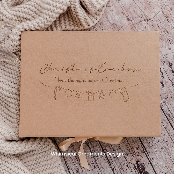 Hello Fern bown kraft keepsake gift box with Christmas-themed etched wording and illustrations on a textured surface.