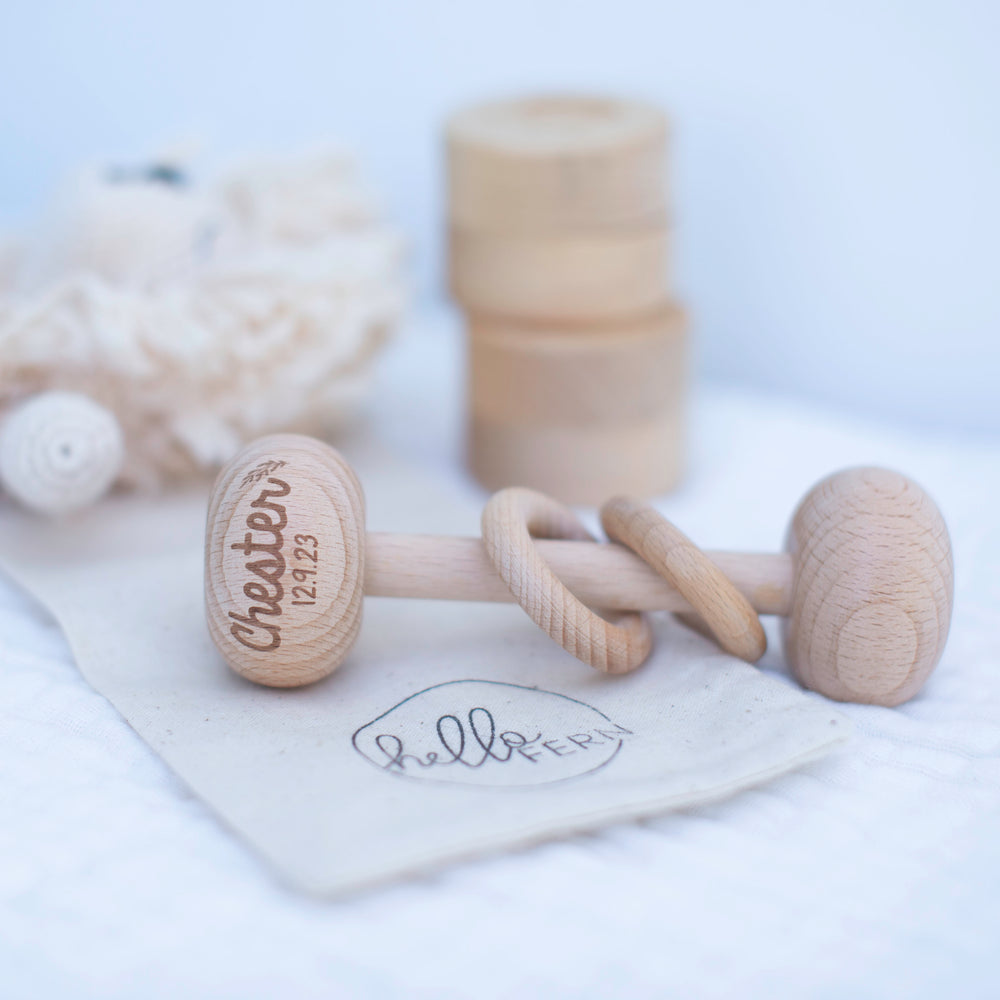 Wooden rattle with custom baby name and birth date details etched on to top of rattle.