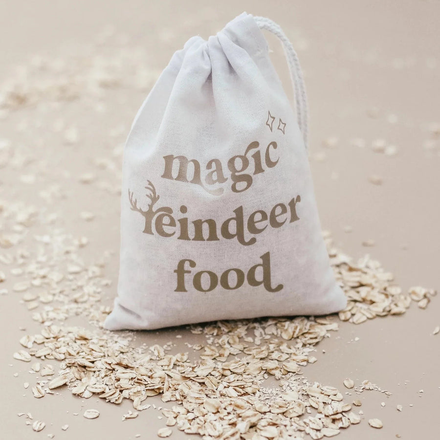 Cotton draw-string bag with the words "magic reindeer food" printed on the front and oats sprinkled around the ground.