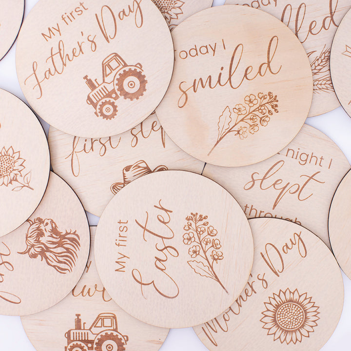 Flat lay of Hello Fern country achievement milestone card discs scattered on table top.