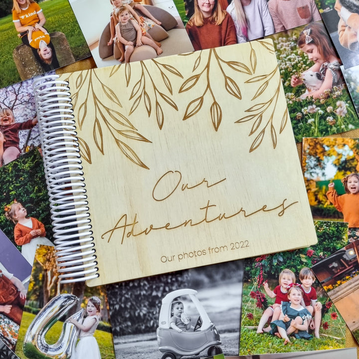 Hello Fern wooden photo album lying on top of table full of family photo memories.