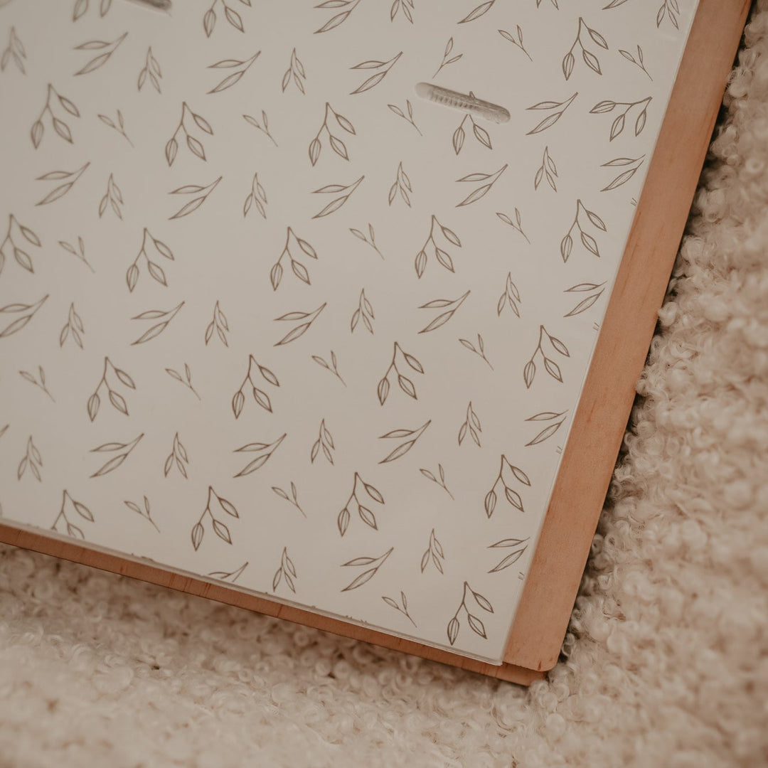 Closeup view of Hello Fern wooden photo album sleeve with botanic design.