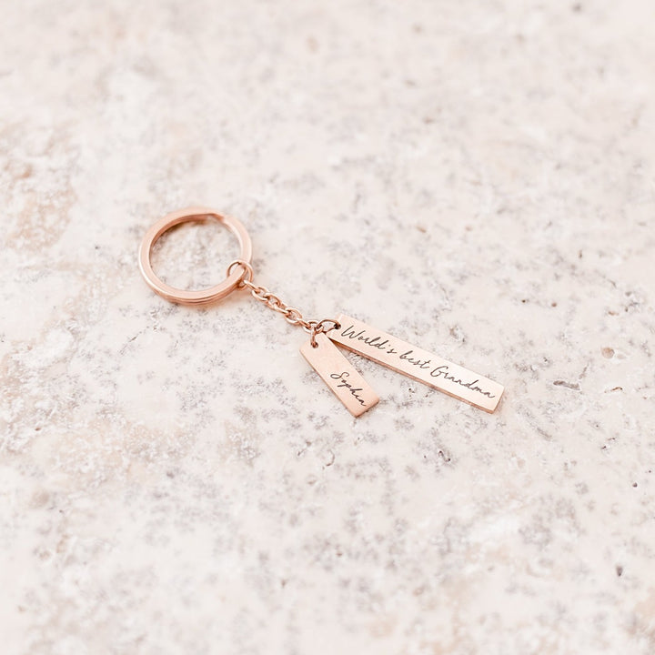Example of custom etched rose gold Mother's Day metal keyring with 'World's best Grandma' message and grandchild's name.