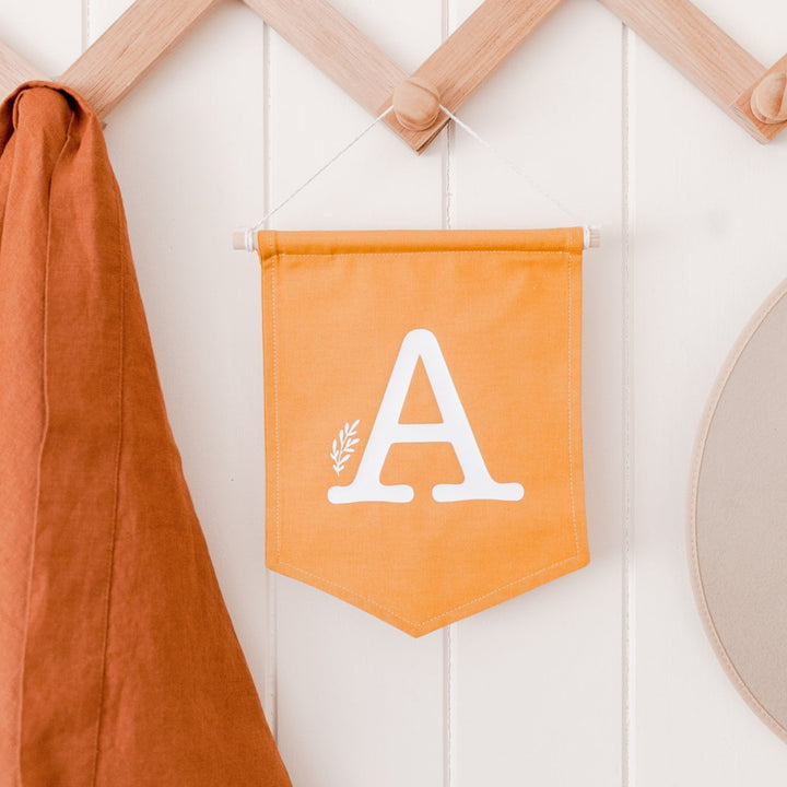Letter flag wall hanging - Mustard with white letter