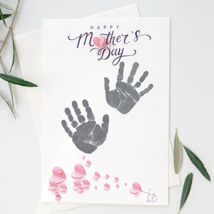 Closeup of baby handprints on "Happy Mother's Day" print sheet from inkless print kit.